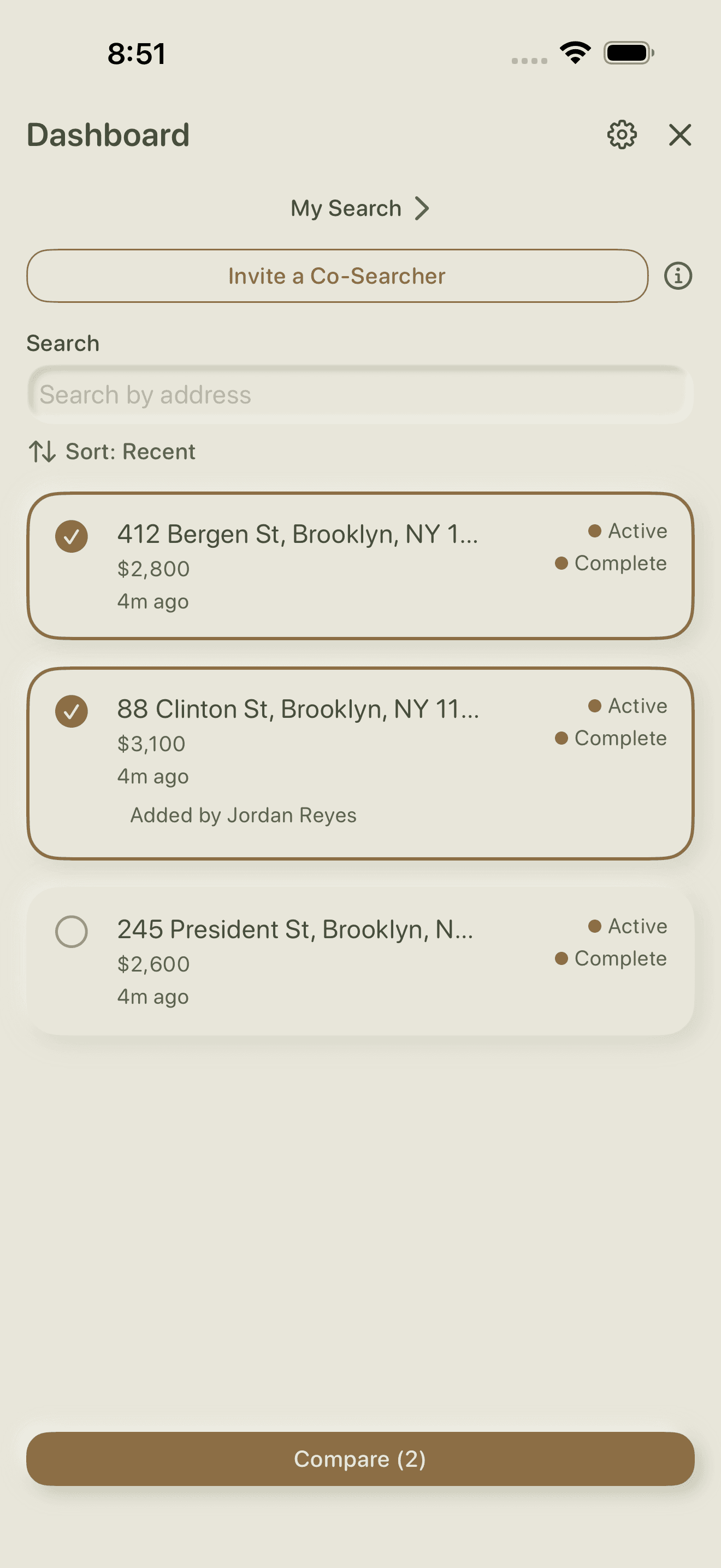Two apartments selected with checkmarks and a Compare button spanning the bottom of the screen.